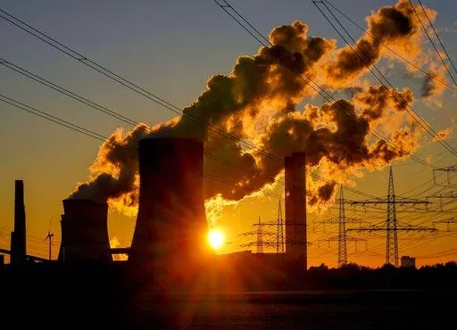 Steam comes out of the chimneys of the coal-fired power station in Niederaussem, Germany, Sunday, Oct. 24, 2021. (AP Photo/Michael Probst, File)