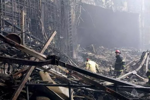 In this photo released by Russian Emergency Ministry Press Service on March 23, 2024, firefighters work in the burned concert hall after an attack on the building of the Crocus City Hall on the western edge of Moscow, Russia. A little-known U.S. intelligence principle called the "duty to warn" came into play ahead of the deadly attack on Moscow's outskirts. U.S. officials invoked that duty when warning Russian officials a full two weeks before Friday's attack. Just three days before the attack, 