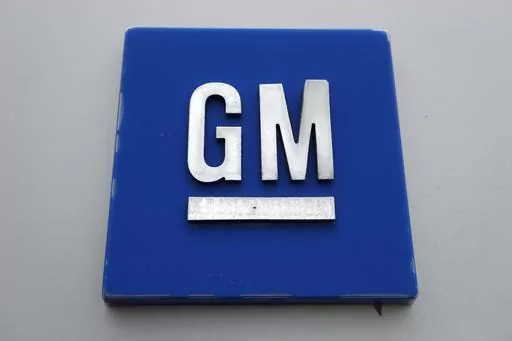 The General Motors logo is displayed outside the General Motors Detroit-Hamtramck Assembly plant, Jan. 27, 2020, in Hamtramck, Mich. General Motors is offering buyouts to most of its U.S. salaried workforce and some global executives in an effort to trim costs as it makes the transition to electric vehicles. (AP Photo/Paul Sancya, File)