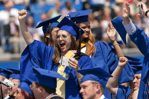 Graduates celebrate during the University of Delaware Class of 2022 commencement ceremony in Newark, Del., Saturday, May 28, 2022. The Department of Education says borrowers who hold eligible federal student loans and have made voluntary payments since March 13, 2020, can get a refund.(AP Photo/Manuel Balce Ceneta)