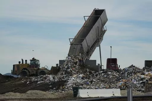 Trash is unloaded at the Otay Landfill in Chula Vista, Calif., on Friday, Jan. 26, 2024. Two years after California launched an effort to keep organic waste out of landfills, the state is so far behind on getting food recycling programs up and running that it's widely accepted next year's ambitious waste-reduction targets won't be met. Over time, food scraps and other organic materials like yard waste emit methane, a gas more potent and damaging in the short-term than carbon emissions from fossi