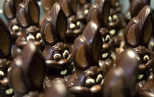 Chocolate rabbits wait to be decorated at the Cocoatree chocolate shop, April 8, 2020, in Lonzee, Belgium. Sweet Easter baskets will likely come at a bitter cost this year for consumers as the price of cocoa climbs to record highs. (AP Photo/Virginia Mayo, File)