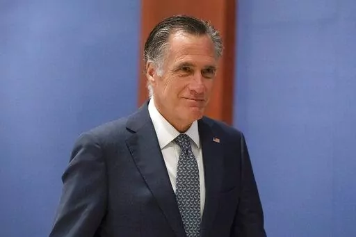 Sen. Mitt Romney, R-Utah, arrives to watch a speech by Ukrainian President Volodymyr Zelenskyy live-streamed into the U.S. Capitol, in Washington, March 16, 2022. Lawmakers seemed on the brink of clinching a bipartisan compromise Thursday, March 31, to provide a fresh $10 billion to combat COVID-19. Romney said bargainers had reach an agreement in principle on a package but said it was still being drafted. Other senators were less definitive but none contested that a deal was near. (AP Photo/Ale