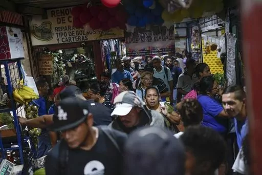 People shop at a street market in the Petare neighborhood of Caracas, Venezuela, Oct. 4, 2023. (AP Photo/Matias Delacroix, File)