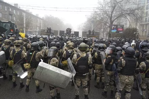 Riot police block a street to prevent demonstrators during a protest in Almaty, Kazakhstan, Wednesday, Jan. 5, 2022. Demonstrators denouncing the doubling of prices for liquefied gas have clashed with police in Kazakhstan's largest city and held protests in about a dozen other cities in the country. (AP Photo/Vladimir Tretyakov)