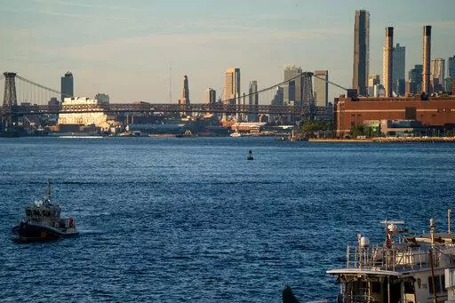 NYPD and Coast Guard boats patrol the East River outside the United Nations headquarters, Tuesday, Sept. 21, 2022, in New York. (AP Photo/Julia Nikhinson)