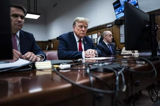 Former President Donald Trump sits in Manhattan criminal court with his legal team in New York, April 15, 2024. A new AP-NORC Center for Public Affairs Research poll found that only about one-third of U.S. adults think Trump did something illegal in the hush money case for which jury selection began Monday, while close to half think he did something illegal in the other three criminal cases pending against him. Still, about half of Americans would consider Trump unfit to serve as president if he