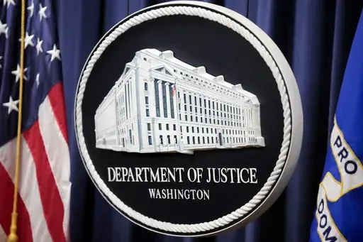 The logo for the Justice Department is seen before a news conference at the Department of Justice, Aug. 23, 2024, in Washington. (AP Photo/Mark Schiefelbein, File)