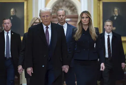 President-elect Donald Trump walks with Melania Trump at the Capitol, Wednesday, Jan. 8, 2025, in Washington, followed by Senate Majority Leader John Thune, R-S.D. (AP Photo/Jose Luis Magana)
