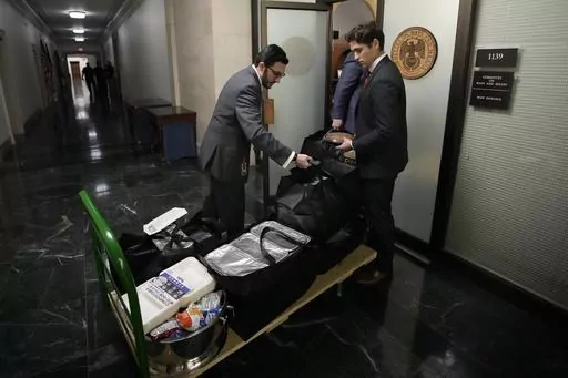 Staff members bring in food before Republicans meet to decide who to nominate to be the new House speaker, on Capitol Hill in Washington, Monday, Oct. 23, 2023. (AP Photo/Alex Brandon)