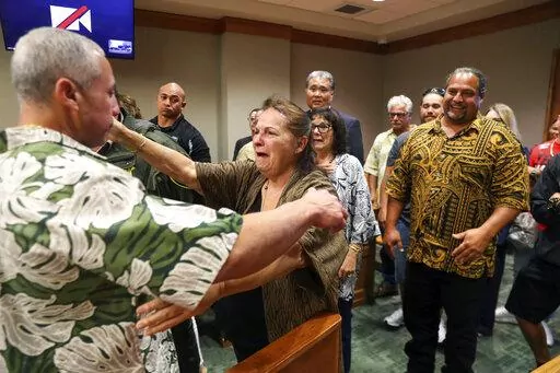 Albert "Ian" Schweitzer, left, hugs his mother, Linda, moments after a judge ordered him released from prison, in Hilo, Hawaii, Tuesday, Jan. 24, 2023. The judge's ruling came immediately after Schweitzer's attorneys presented new evidence and argued that Schweitzer didn’t commit the crimes he was convicted of and spent more than 20 years locked up for: the 1991 murder, kidnapping and sexual assault of a woman visiting Hawaii. (Marco Garcia/The Innocence Project via AP Images)