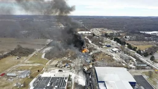 This photo taken with a drone shows portions of a Norfolk and Southern freight train that derailed Friday night in East Palestine, Ohio are still on fire at mid-day Saturday, Feb. 4, 2023. The federal government filed a lawsuit Thursday, March 30, against railroad Norfolk Southern over environmental damage caused by a February derailment on the Ohio-Pennsylvania border that spilled hazardous chemicals into nearby creeks and rivers. (AP Photo/Gene J. Puskar, File)