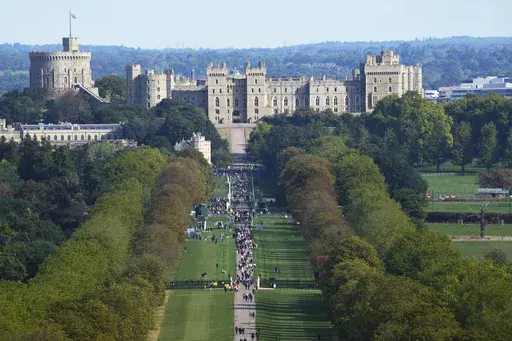 People make their way along the Long Walk towards Windsor Castle in Windsor, England, Sept. 18, 2022. (AP Photo/Gregorio Borgia, File)