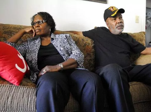 Sarah Collins Rudolph and her husband, George Rudolph, talk in their home on Nov. 16, 2016, in Birmingham, Ala. Rudolph lost an eye and still has slivers of glass inside her body from the racist bombing that killed her sister and three other Black girls inside a church 59 years ago Thursday. She's still waiting on the state to compensate her for those injuries. (AP Photo/Jay Reeves, File)