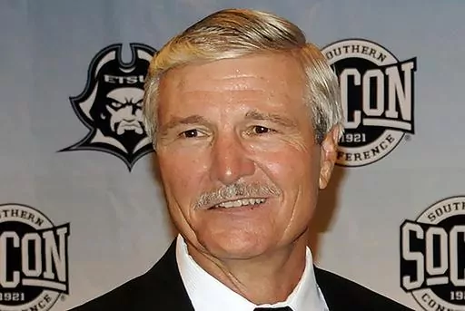 Carl Torbush poses after being introduced as the NCAA college football head coach at East Tennessee State, Friday, June 21, 2013, in Johnson City, Tenn. Torbush, a defensive specialist who succeeded Mack Brown as North Carolina's head football coach after Brown’s first tenure and later coached at East Tennessee State, has died. He was 72. ETSU said Monday that Torbush died Sunday, Nov. 5, 2023. (David Boyd/The Johnson City Press via AP, File)