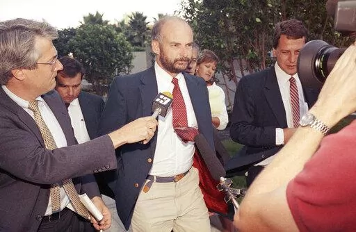 Former Exxon Valdez Capt. Joseph Hazelwood is surrounded by reporters as he leaves his re-licensing hearing in Long Beach, Calif., on July 25, 1990. Hazelwood, the captain of the Exxon Valdez oil tanker that ran aground more than three decades ago in Alaska, causing one of the worst oil spills in U.S. history, has died in July 2022, the New York Times reported. He was 75. (AP Photo/Alan Greth, File)
