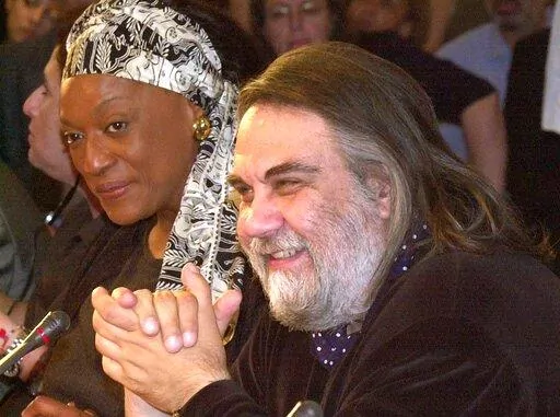 Composer Vangelis Papathanassiou, right, answers a question during a press conference in Athens, June 27, 2001. Vangelis, the Greece-born electronic composer who wrote the Academy Award-winning score for the film "Chariots of Fire" and music for dozens of other movies, documentaries and TV series, has died. He was 79. (AP Photo/Aris Messinis, File)