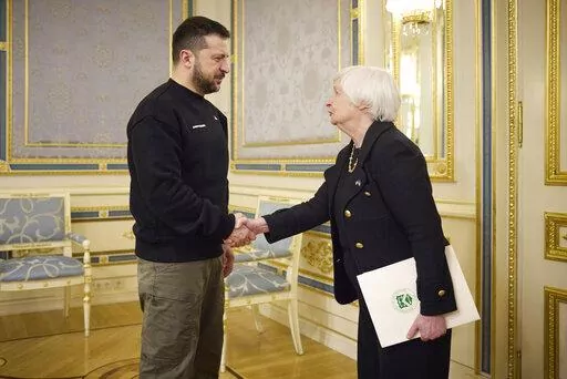 Ukrainian President Volodymyr Zelenskyy, left, and U.S. Treasury Secretary Janet Yellen shake hands during their meeting in Kyiv, Ukraine, Monday, Feb. 27, 2023. (Ukrainian Presidential Press Office via AP)