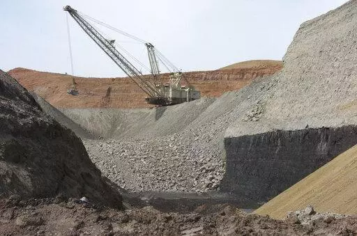In this April 4, 2013, file photo, a dragline excavator moves rocks above a coal seam at the Spring Creek Mine in Decker, Mont. A federal judge has reinstated a moratorium on coal leasing from federal lands that was imposed under former President Barack Obama and then scuttled under former President Donald Trump, Friday, Aug. 12, 2022. (AP Photo/Matthew Brown, File)