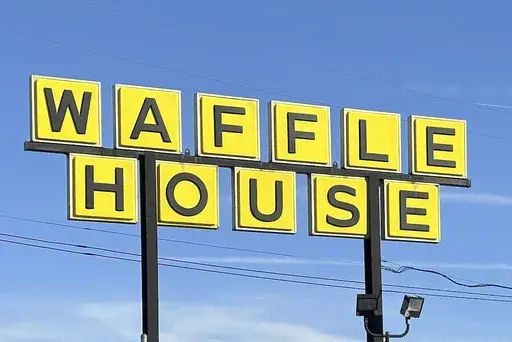 A Waffle House sign is shown in Indianapolis Feb. 19, 2024. Waffle House is increasing pay for its U.S. workers after a year-long push from labor advocates.(AP Photo/Isabella Volmert, File)