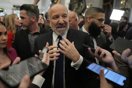 Secretary of Commerce Howard Lutnick speaks with reporters after President Donald Trump addressed a joint session of Congress at the Capitol in Washington, Tuesday, March 4, 2025. (AP Photo/Ben Curtis)
