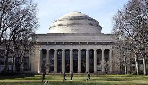 Students walk past the "Great Dome" atop Building 10 on the Massachusetts Institute of Technology campus, April 3, 2017, in Cambridge, Mass. The Justice Department dropped its case Thursday, Jan. 20, 2022 against MIT professor Gang Chen, charged last year with hiding work he did for the Chinese government, saying it "could no longer meet its burden of proof at trial." Chen was accused last year of concealing ties to Beijing while also collecting U.S. dollars for his nanotechnology research. (AP 
