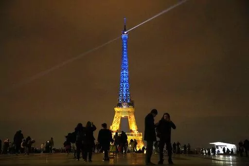 The Eiffel Tower is illuminated with the colors of Ukraine to mark the one-year anniversary of Russia's invasion of the country, in Paris, Thursday, Jan. 23, 2023. (AP Photo/Christophe Ena)