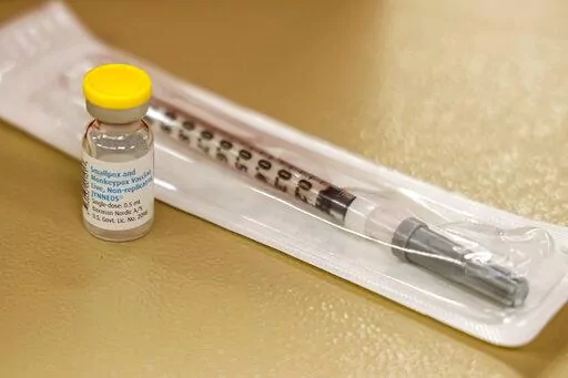 A vial containing the monkeypox vaccine and a syringe is set on the table at a vaccination clinic run by the Mecklenburg County Public Health Department in Charlotte, N.C., Saturday, Aug. 20, 2022. In the wake of a study released on Thursday, Sept. 8, 2022, U.S. officials are considering broadening recommendations for who gets vaccinated against monkeypox, possibly to include many men being treated for HIV or those who recently had other sexually transmitted infections. (AP Photo/Nell Redmond, F