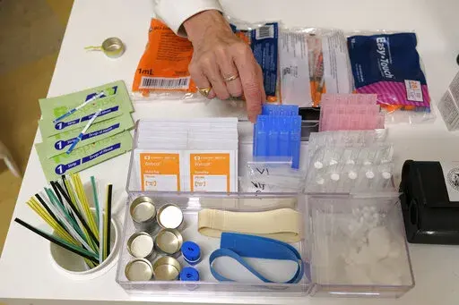 Supplies are shown on a desk at Safer Inside, a realistic model of a safe injection site in San Francisco,  Aug. 29, 2018. The Justice Department is signaling it might be open to allowing so-called safe injection sites, or safe havens for people to use heroin and other narcotics with protections against fatal overdoses. The department's stance comes a year after federal prosecutors won a major court ruling that found the sites would violate federal law. The Justice Department tells The Associate