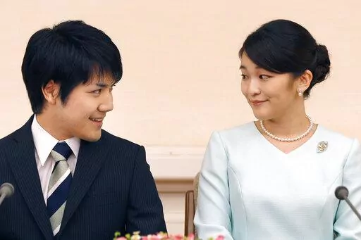 Japan's Princess Mako and her fiance Kei Komuro look at each other during a press conference at Akasaka East Residence in Tokyo on Sept. 3, 2017.  Komuro has passed the New York bar exam, defying detractors back home who had criticized their romance. (AP Photo/Shizuo Kambayashi, Pool, File)