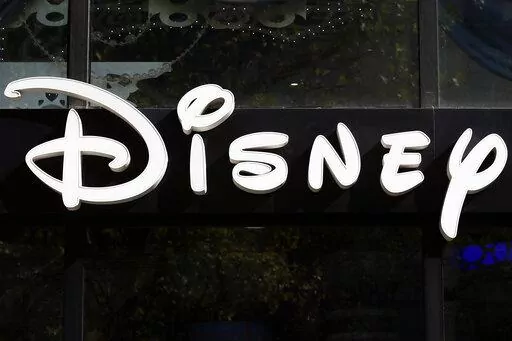This Sept. 20, 2017, file photo shows a sign at the Disney store on the Champs Elysees Avenue in Paris, France.  The Supreme Court’s decision to end the nation’s constitutional protections for abortion has catapulted businesses of all types into the most divisive corner of politics. A rash of iconic names including The Walt Disney Company, Facebook parent Meta, and Goldman Sachs announced they would pay for travel expenses for those who want the procedure but can't get it in the states they 