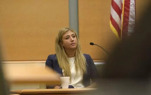 Brittany Paz, a lawyer hired by Alex Jones to testify about his companies, is questioned by plaintiff's attorney Chris Mattei during Jones' Sandy Hook defamation damages trial in Superior Court in Waterbury, Conn., on Thursday, Sept. 15, 2022. (H John Voorhees III/Hearst Connecticut Media via AP, Pool)