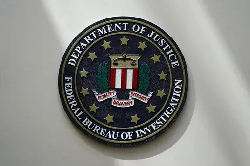 An FBI seal is seen on a wall on Aug. 10, 2022, in Omaha, Neb. (AP Photo/Charlie Neibergall, File)