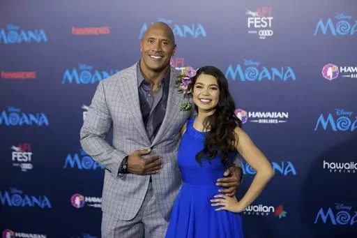 Actors Dwayne Johnson, left, and Auli'i Cravalho appear at the 2016 AFI Fest - "Moana" world premiere in Los Angeles on Nov. 14, 2016. Disney chief executive Bob Iger on Monday announced that a live-action “Moana” remake is in development in a call with investors. The production is in the early stages, but Dwayne Johnson is set to return as the demigod Maui. Cravalho, who voiced Moana in the original, is to be an executive producer on the live-action version. (Photo by Willy Sanjuan/Invision