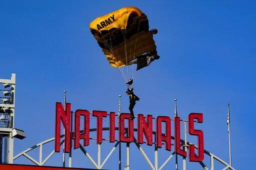 The U.S. Army Parachute Team the Golden Knights descend into National Park before a baseball game between the Washington Nationals and the Arizona Diamondbacks Wednesday, April 20, 2022, in Washington. The U.S. Capitol was briefly evacuated after police said they were tracking an aircraft “that poses a probable threat,” but the plane turned out to be the military aircraft with people parachuting out of it for a demonstration at the Nationals game, officials told The Associated Press. (AP Pho