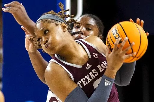 Texas A&M's Janiah Barker grabs a rebound in front of a Mississippi State defender in the first half of an NCAA college basketball game during the Southeastern Conference women's tournament in Greenville, S.C., Thursday, March 2, 2023. (AP Photo/Mic Smith)