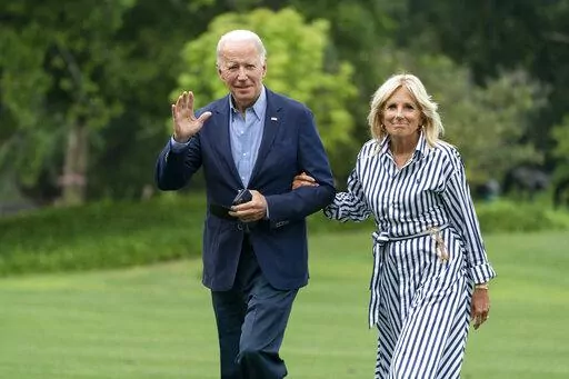 President Joe Biden with first lady Jill Biden waves as they walk on the South Lawn of the White House in Washington, upon arrival from a trip to visit flood affected areas in Kentucky, Monday, Aug. 8, 2022. (AP Photo/Manuel Balce Ceneta)