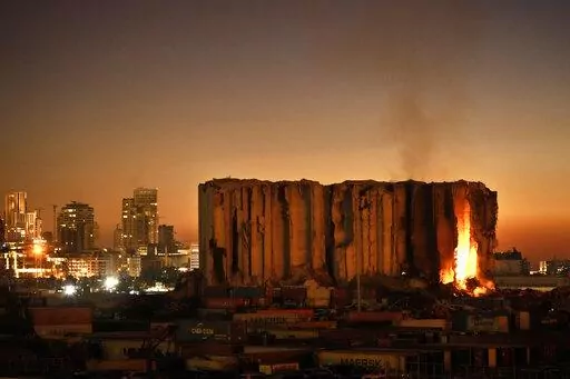 Silos in the north block of the Beirut Port, that were destroyed by a massive explosion in 2020, have caught fire due to fermented grains in Beirut, Lebanon, Sunday, July 24, 2022. It has been two years since a warehouse full of ammonium nitrate at Beirut's port exploded, destroying large parts of the city, killing more than 215 people and injuring thousands. Many families are losing hope of ever finding justice. (AP Photo/Hassan Ammar, File)