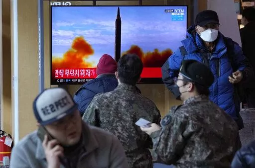 People watch a TV showing a file image of North Korea's missile launch during a news program, at the Seoul Railway Station in Seoul, South Korea, Sunday, Feb. 27, 2022. North Korea on Sunday launched a suspected ballistic missile into the sea, South Korean and Japanese officials said, in an apparent resumption of its weapons tests following the end of the Winter Olympics in China, the North's last major ally and economic pipeline. (AP Photo/Ahn Young-joon)