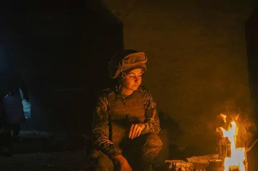 In this photo provided by Azov Special Forces Regiment of the Ukrainian National Guard Press Office, A Ukrainian woman soldier inside the ruined Azovstal steel plant take a rest in his shelter in Mariupol, Ukraine, May 10, 2022. For nearly three months, Azovstal’s garrison clung on, refusing to be winkled out from the tunnels and bunkers under the ruins of the labyrinthine mill. A Ukrainian soldier-photographer documented the events and sent them to the world. Now he is a prisoner of the Russi
