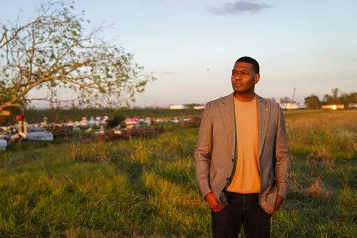 EPA Administrator Michael Regan poses for a photo for his EPA photographer near a cemetery in a neighborhood next to the Nu Star Energy oil storage tanks, after conducting a television interview, in St. James Parish, La., Nov. 16, 2021. Regan visited low-income, mostly minority communities in Mississippi, Louisiana and Texas as part of an effort to focus federal attention on communities adversely affected by decades of industrial pollution.  (AP Photo/Gerald Herbert, File)