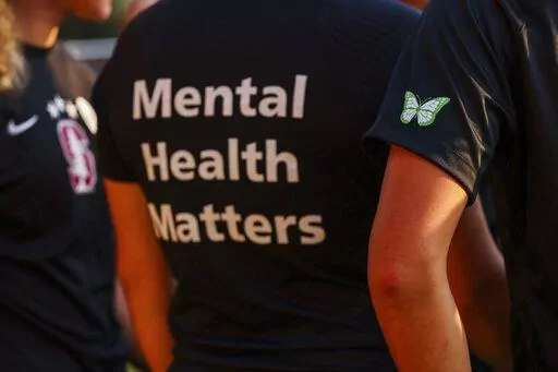 Stanford women's soccer team players wear warmup jerseys with "Mental Health Matters" on their backs as well as a butterfly patch on their sleeves to remember late goalie Katie Meyer, who died by suicide earlier in the year, before an NCAA college soccer match against UCLA, Oct. 14, 2022, in Stanford, Calif. The COVID-19 pandemic took an especially harsh toll on U.S. teen girls’ mental health, with almost 60% reporting feelings of persistent sadness or hopelessness, according to a government s