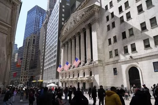 Pedestrians walk past the New York Stock Exchange building on March 25, 2024, in New York. Global shares have mostly declined on Friday, April 5, 2024, as investors looked to a key U.S. jobs report due later in the day to gauge the health of the economy and see what the Federal Reserve might do on interest rates. (AP Photo/Frank Franklin II, File)