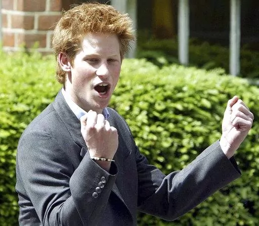 Britain's Prince Harry, 18, punches the air as he leaves Eton College on his last day at the top public school where he has been a pupil for five years, in Windsor, England, on June 12, 2003. An explosive memoir reveals many facets of Prince Harry, from bereaved boy and troubled teen to wartime soldier and unhappy royal. From accounts of cocaine use and losing his virginity to raw family rifts, “Spare” exposes deeply personal details about Harry and the wider royal family. It is dominated by