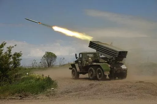 A Donetsk People's Republic militia's multiple rocket launcher fires from its position not far from Panteleimonivka, in territory under the government of the Donetsk People's Republic, eastern Ukraine, Saturday, May 28, 2022. Day after day, Russia is pounding the Donbas region of Ukraine with relentless artillery and air raids, making slow but steady progress to seize the industrial heartland of its neighbor. With the conflict now in its fourth month, it’s a high-stakes campaign that could dic