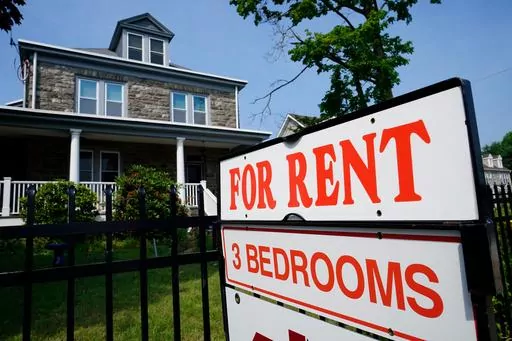A sign indicating the availability of a home to rent stands outside a building in Philadelphia, Wednesday, June 22, 2022. Remote working has led to so-called “bleisure” travel, where employees mix work and leisure on the same trip. This trend appears to be affecting the lodging industry, with demand for short-term rentals such as Airbnb outpacing that for hotels. With more and more travelers working on vacation — and extending their trips to do so — they’re looking for the amenities sh