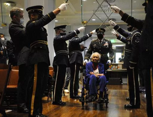 Romay Davis, 102, enters a ceremony honoring her service in World War II during a ceremony in Montgomery, Ala., on Tuesday, July 26, 2022. Davis is the old surviving member of the 6888th Central Postal Directory Battalion, which helped clear out a backlog of millions of letters and packages late in the war in Europe. (AP Photo/Jay Reeves)