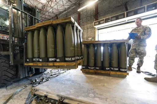 U.S. Air Force Staff Sgt. Cody Brown, right, with the 436th Aerial Port Squadron, checks pallets of 155 mm shells ultimately bound for Ukraine, April 29, 2022, at Dover Air Force Base, Del. The Biden administration has announced another $1 billion in new military aid for Ukraine. The Aug. 8 pledge promises what will be the biggest yet delivery of rockets, ammunition and other arms straight from Department of Defense stocks for Ukrainian forces. (AP Photo/Alex Brandon, File)