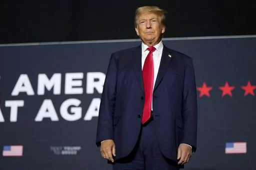Former President Donald Trump arrives at a rally, Sunday, Oct. 1, 2023, in Ottumwa, Iowa. Trump is campaigning in a part of the state that he flipped from Democratic control in 2016. (AP Photo/Charlie Neibergall)