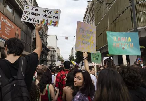People raise placards as they participate in the annual Pride parade, in Athens, on June 10, 2023. Greece's center-right government said on Thursday, Dec. 21, 2023, it would fulfill a commitment to legalize same-sex marriage, sidestepping staunch opposition from the country's influential Orthodox Church. (AP Photo/Yorgos Karahalis, File)